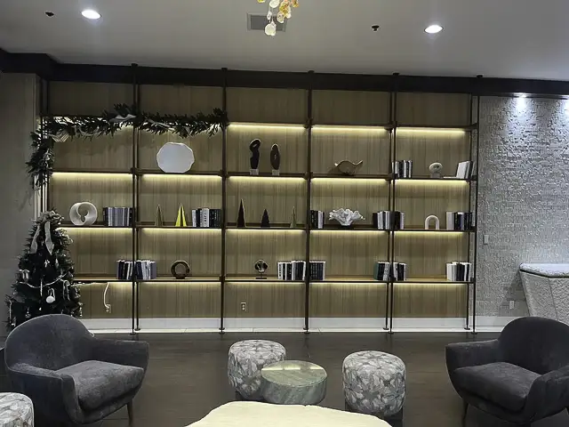 A modern, well-lit shelving unit with decorative items and books.