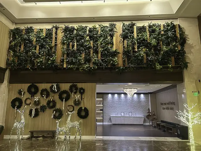 An indoor space with a green wall and a reception area.