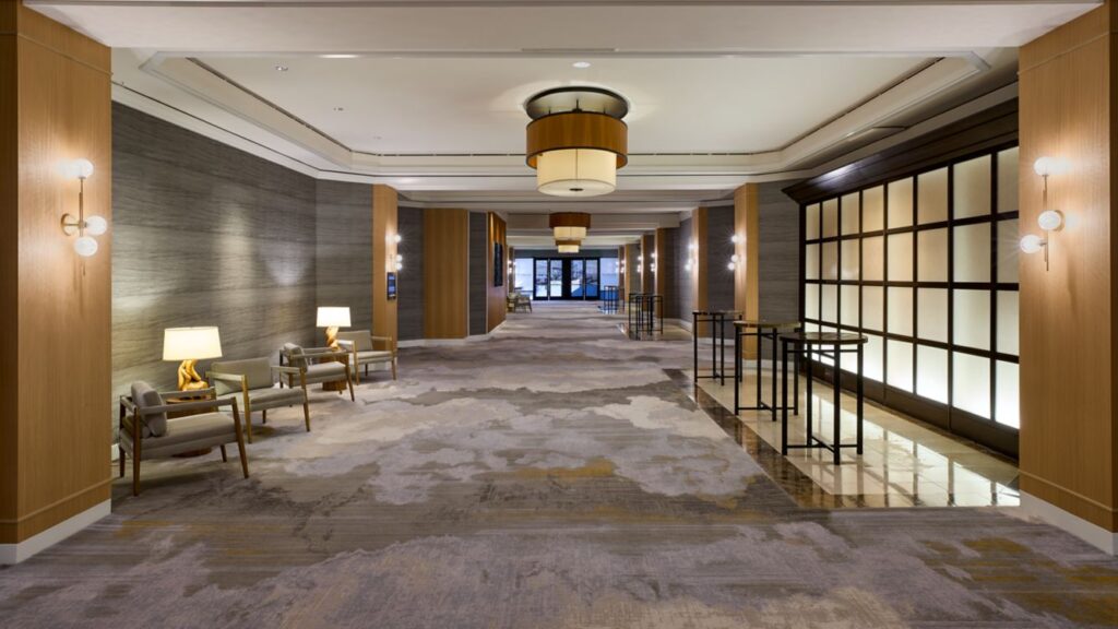 A spacious hotel lobby with elegant lighting and seating.