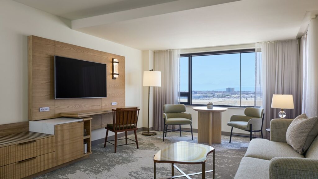 Modern hotel room with ocean view and stylish furniture.